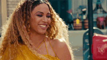 Music video gif. Beyonce gives us a wide laugh during her music video for Lemonade. She tosses her head back and heartily laughs, unbothered by anything as she makes eye contact with us and struts away.