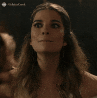 Schitt's Creek gif. Annie Murphy as Alexis is listening to someone's good news and reacting with an overdramatic, "Wow! Wow! Wowee!" She's shocked and trying to cover up her shock with overexcitement.
