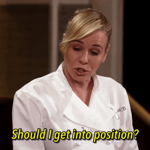 TV gif. Chelsea Handler, dressed as a chef, speaks plainly to bottom of frame. Text, "Should I get into position?"