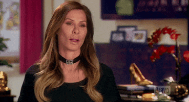 Reality TV gif. Carole Radziwill from Real Housewives of New York is being interviewed and she sticks her tongue out and blows a raspberry.
