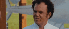 Movie gif. John C. Reilly as Dale in Step Brothers squints quizzically and turns his head to look forward while someone talks to him.