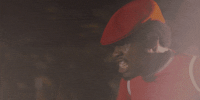 Movie gif. Shameik Moore as Curtis "Shaolin Fantastic" Caldwell from The Rundown furiously pumps his arms as he speeds down the road in a red cap.