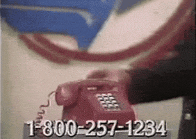 Video gif. A suited man picks up a hotline telephone on an infomercial, saying with a straight face, "Call someone who cares."