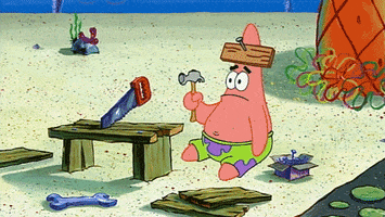 SpongeBob gif. Patrick sits on the ground and looks confused, holding a hammer, with a plank of wood nailed to his forehead.