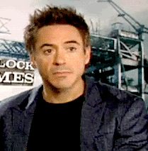 Celebrity gif. Robert Downey Jr. is being interviewed and he's speechless, unsure of what to say. He opens his mouth and closes it and reaches a hand out and takes it back and clutches his hair in frustration.