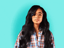 Celebrity gif. H.E.R. looks blankly confused and holds her hand up in a gesture of "what the heck." Text, "What."