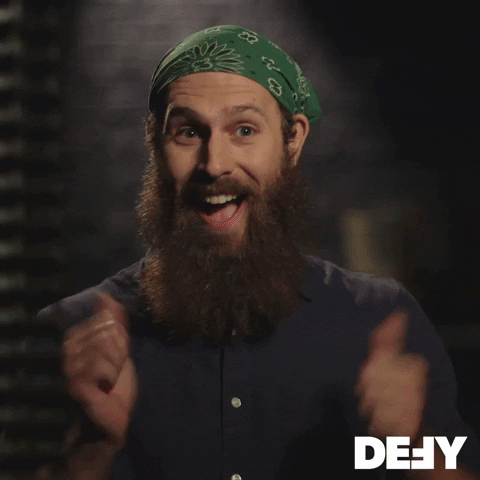 TV gif. Man with a long beard on Forged in Fire smiles widely and holds up two enthusiastic thumbs up.