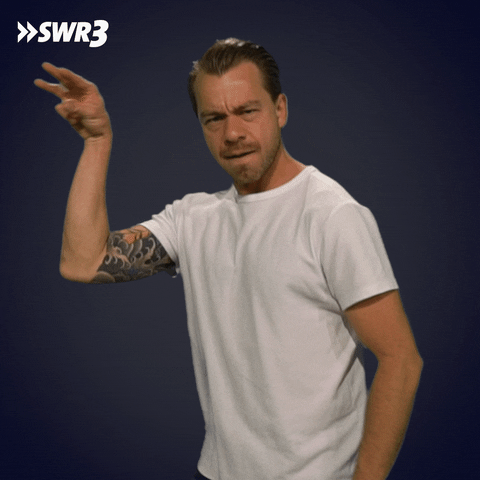 Video gif. Kemal Goga from the German radio show SWR3, bites his lip and makes a seasoning-sprinkling motion with his hand, like the Salt Bae.