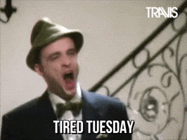 Celebrity gif. Singer Fran Healy of the band Travis yawns deep in a green wool hat. Text, "Tired Tuesday."
