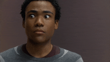 TV gif. Donald Glover looks at something fearfully, his eyes wide and his face unmoving,.