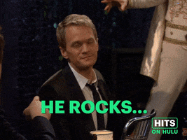 Sponsored GIF. Jason Segal and Neil Patrick Harris sit in a bar conversing. Jason Segal pauses to reassure NPH that "He rocks ...infinity" and points with his finger upward and continues to gesture with an arc in the air. NPH smiles and nods with appreciation and levity.