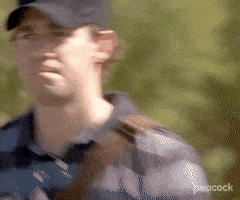 The Office gif. John Krasinski as Jim wearing a black baseball cap, looks directly at us and gives a patented upside-down smile of confusion.