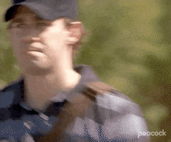 The Office gif. John Krasinski as Jim wearing a black baseball cap, looks directly at us and gives a patented upside-down smile of confusion.
