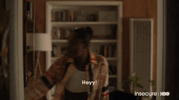 TV gif. Issa Rae as Issa on Insecure. She opens a door with a wide smile and is slightly bent over with a hand on her thigh. She says, "Heyyyyy!" while welcoming them in excitedly.