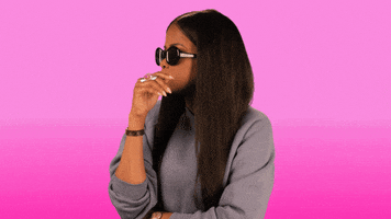 Video gif. Against a pink gradient background, wearing a gray sweatshirt and sunglasses, Karen Civil tilts her shades at us and shakes her head slightly as she plainly says: Text, "No."