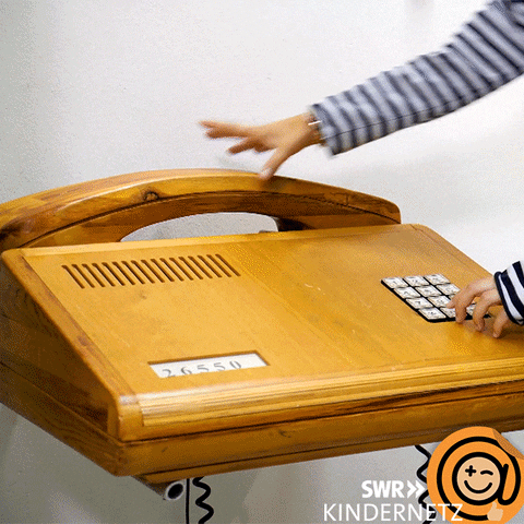 Video gif. A woman answers a giant telephone, says something quickly, then sets the receiver back down.