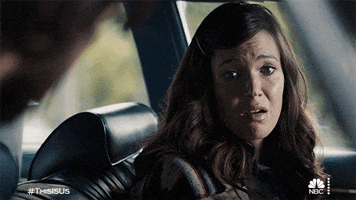 TV gif. Mandy Moore as Rebecca in This Is Us. She's sitting in the driver's seat of a car and looks around before grimacing and looking sorry.