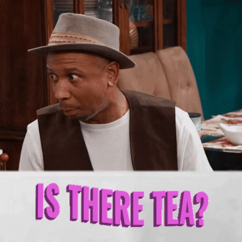 Video gif. A man wearing a hat and vest looks from one direction to the other, wide-eyed, searching, and hopeful. Text, "Is there tea?"