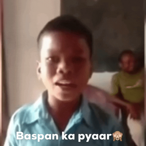 Video gif. A young boy looks straight ahead and speaks passionately. Text, "Baspan ka pyaar". An emoji with a monkey covering his eyes at the end of the text. 