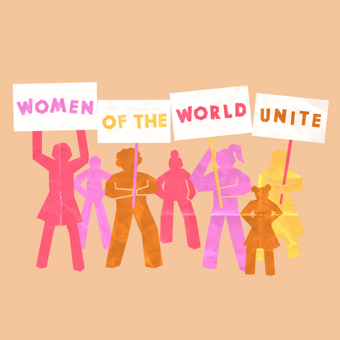 Digital art gif. Cutouts of different shades of yellow, pink, orange, and gold women are holding signs that say, "Women of the world unite!"