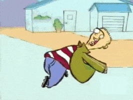 Cartoon gif. Ed with one d on Ed, Edd, and Eddy runs excitedly down the street. He runs leaning back with his arms loosely catching in the wind. His mouth is open in a big smile with his tongue sticking out. 