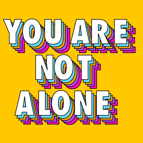Digital art gif. In white, all-caps text with rainbow shadows, bouncing letters spell out "You are not alone," against a yellow background.