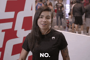 Sports gif. Claudia Gadelha, a UFC fighter, draws her hand across her throat and says, "No," letting us know that taking her down is never going to be an option.
