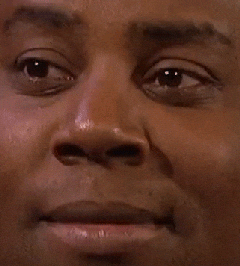 Celebrity gif. An extremely close up shot of Kenan Thompson with only his expression showing as he scrunches up his face in a questioning, are-you-sure manner.