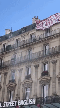 Man Damages 'White Lives Matter' Banner Hanging Over Paris Anti-Racism Protest