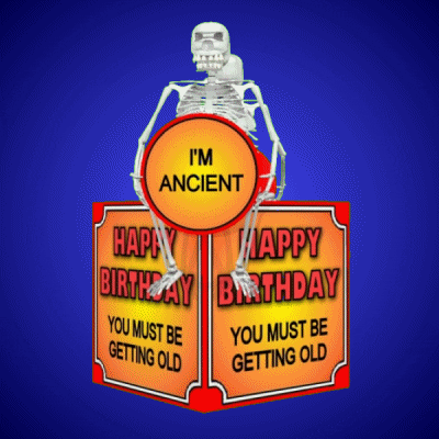Digital art gif. Two skeletons sit on a rotating box holding signs that say, “I’m ancient.” On each side of the box text reads, “Happy Birthday. You must be getting old.”