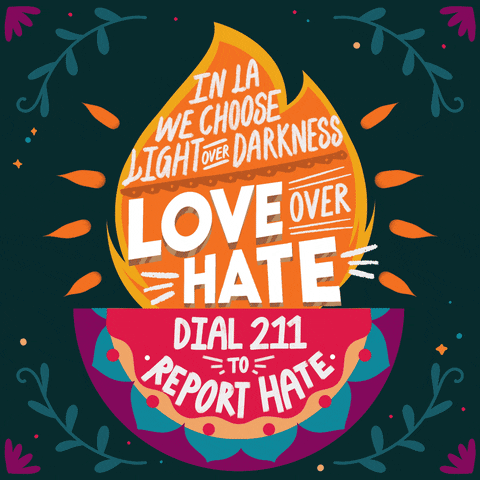 Digital art gif. Diwali flame in an ornate folk art diyas in rich jewel tones on a forest green background, petals vines and twinkles all around, stylized text across the flame. Text, "In LA we choose light over darkness and love over hate. Dial 211 to report hate."