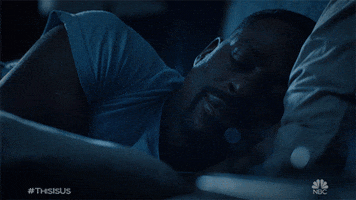 TV gif. Sterling K. Brown as Randall lies in bed in the dark, sleeping peacefully.