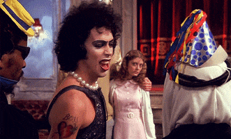 tim curry tossing drink GIF