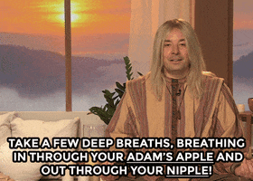 Tonight Show gif. Jimmy Fallon dressed in a meditative yogi outfit with a wig of long, blonde hair sits against a window that overlooks an enchanting sunset over a hilly terrain. He sits cross-legged and has lit candles next to him as he says, "Take a few deep breaths, breathing in through your Adam's Apple and out through your nipple!"