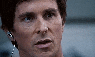 Movie gif. Christian Bale as Michael in The Big Short reacts with a wide, jovial smile.
