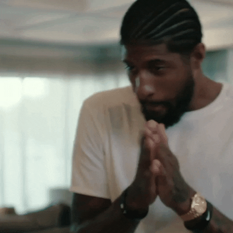 Sports gif. LA Clippers player Paul George rubs his palms together in anticipation.