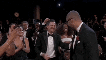Oscars 2024 GIF. Cord Jefferson, at the Oscars, up from his seat, leans in to kiss his dad’s bald head, then exchanging a kiss of greeting.