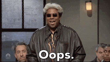 SNL gif. Kenan Thompson in sunglasses and a leather jacket shrugs as he chuckles and says, "Ooops."
