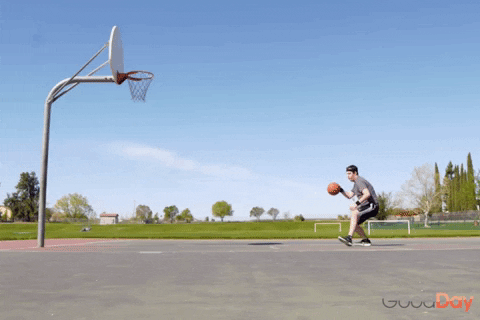 A man shoots a basketball and falls short of the basket.
