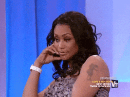 Reality TV gif. Tami Roman from Basketball Wives rests her head on her hand and gently rocks in annoyance with a serious expression.