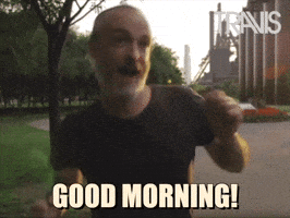 Video gif. Fran Healy, frontman of the band Travis jumps up and down giddy with excitement. Text, Good Morning!"