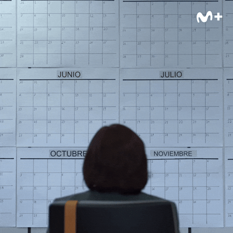Person using a pen to cross a task off a productivity paper card.