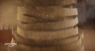 Cartoon gif. Murray the Mummy from Hotel Transylvania: Transformania stands in a party room. His bandages fall around him and he looks down at his human body in shock. He looks up confused and says, “What the…?”