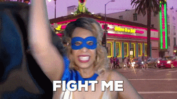 ComedianHollyLogan mask superhero fighting costume GIF