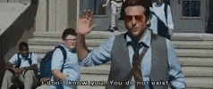 Movie gif. Bradley Cooper as Phil in The Hangover power walking away from a school, waves off a student saying "I don't know you, you do not exist."