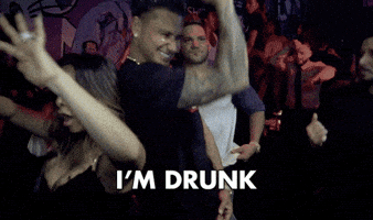 TV gif. In a crowded nightclub, a grinning Pauly D from Jersey Shore Family Vacation pumps his arm as if pulling a truck horn, then puts a hand to his chest for a confession: Text, "I'm drunk."