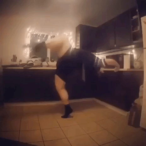Dancer Films Stretching Routine While Waiting on Microwave