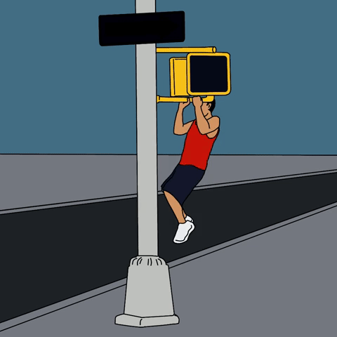 Man doing pull-ups at a crosswalk 