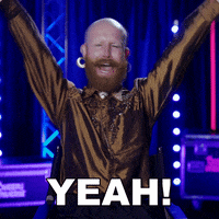 Reality TV gif. Gingzilla smiles and laughs, throwing his arms up and shouting "yeah!" with joy. 