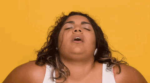 Video gif. Woman's head is leaned back in pleasure, her eyes closed and mouth open.